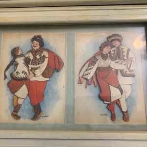 Two framed Yaroslava Mills Ukrainian Folk Dancer art pieces.
